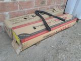 a box that is sitting on the ground next to a brick wall