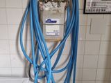 a blue hose attached to a white toilet in a bathroom