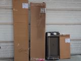 a pile of boxes and a television in front of a garage door