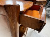 a wooden desk with a drawer on top of it