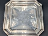 an antique silver plate on a black background