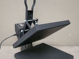 an image of a black heat presser sitting on top of a table