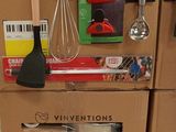 a stack of cardboard boxes with kitchen utensils on them