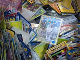 a large pile of pokemon cards in a cardboard box