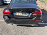 a black mercedes car parked in a parking lot