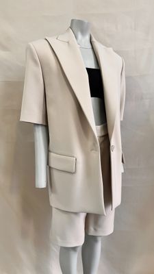 the mannequin is wearing a white suit and black top