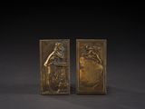 pair of bronze bookends depicting a woman and a man