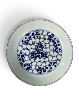 a blue and white plate with a design on it