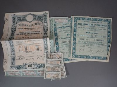 several old paper currency are displayed on a gray surface