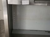 a stainless steel oven with a door open in a kitchen