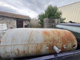 a rusted tank sitting in the back of a pickup truck