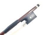 a violin bow and a bow rest on a white surface
