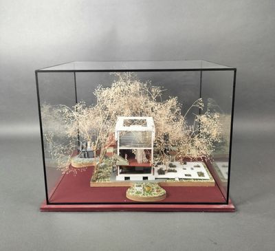 a miniature model of a house in a glass case
