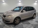 a picture of a silver car parked on a checkered floor
