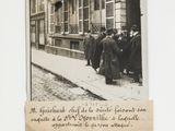 an old photo of a group of people standing outside of a building