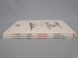 three books are stacked on top of each other on a table