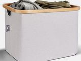 a close up of a white laundry basket with clothes in it