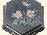 a black box with a bird and flowers painted on it