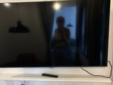 a flat screen tv mounted on the wall in the living room