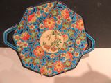 a blue and red plate with a bird on it