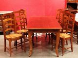 a table and chairs in a room with a red wall