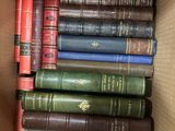 a box full of old books sitting on a table