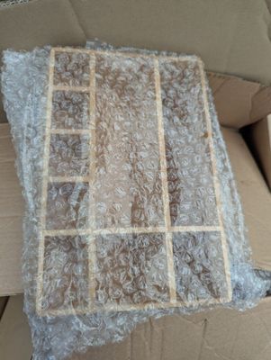 a cardboard box with a piece of plastic wrapped in it