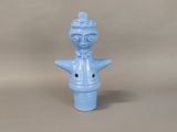a small blue figurine with a crown on it