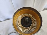 a silver and gold vase with a spider on it