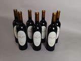quatre bouteilles de vin sont alignées sur une table