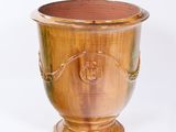 a wooden vase with a metal handle on a white background
