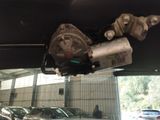 many cars parked in a garage and one has a water pump attached to it