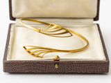 an image of a pair of gold cuff bracelets in a box