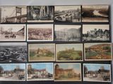 an old photo of a bunch of old postcards on a table