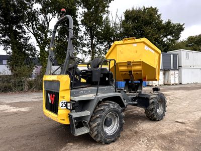 un camion-benne garé sur un terrain en terre battue