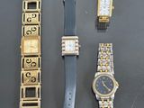 three watches and a watch bracelet are sitting on a table
