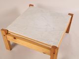 a small table with a marble top on a white background