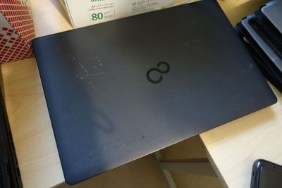 a laptop that is sitting on a table with a box