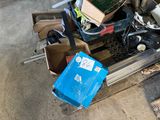 a pile of junk sitting on the ground next to a blue box