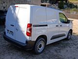 a white van parked in a parking lot next to a building