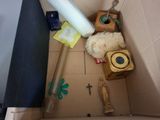 a cardboard box with a teddy bear and other items in it