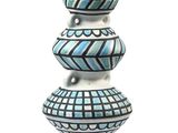 a blue and white vase sitting on top of a white table