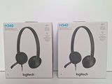 two boxes of headphones sitting on top of a white table