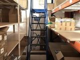 a ladder in the middle of a room with boxes on the shelves