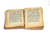 an open book with writing on it sitting on a table