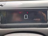 a car dashboard with a digital clock on it ' s display