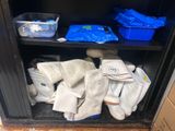 a cabinet with a bunch of gloves and other items on it