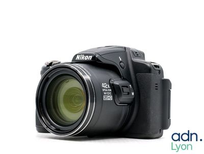 a digital camera that is sitting on a white surface