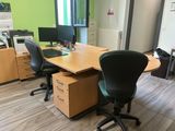 a desk with two chairs and a computer on it