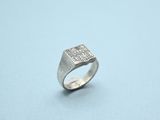 a close up of a silver ring on a blue surface